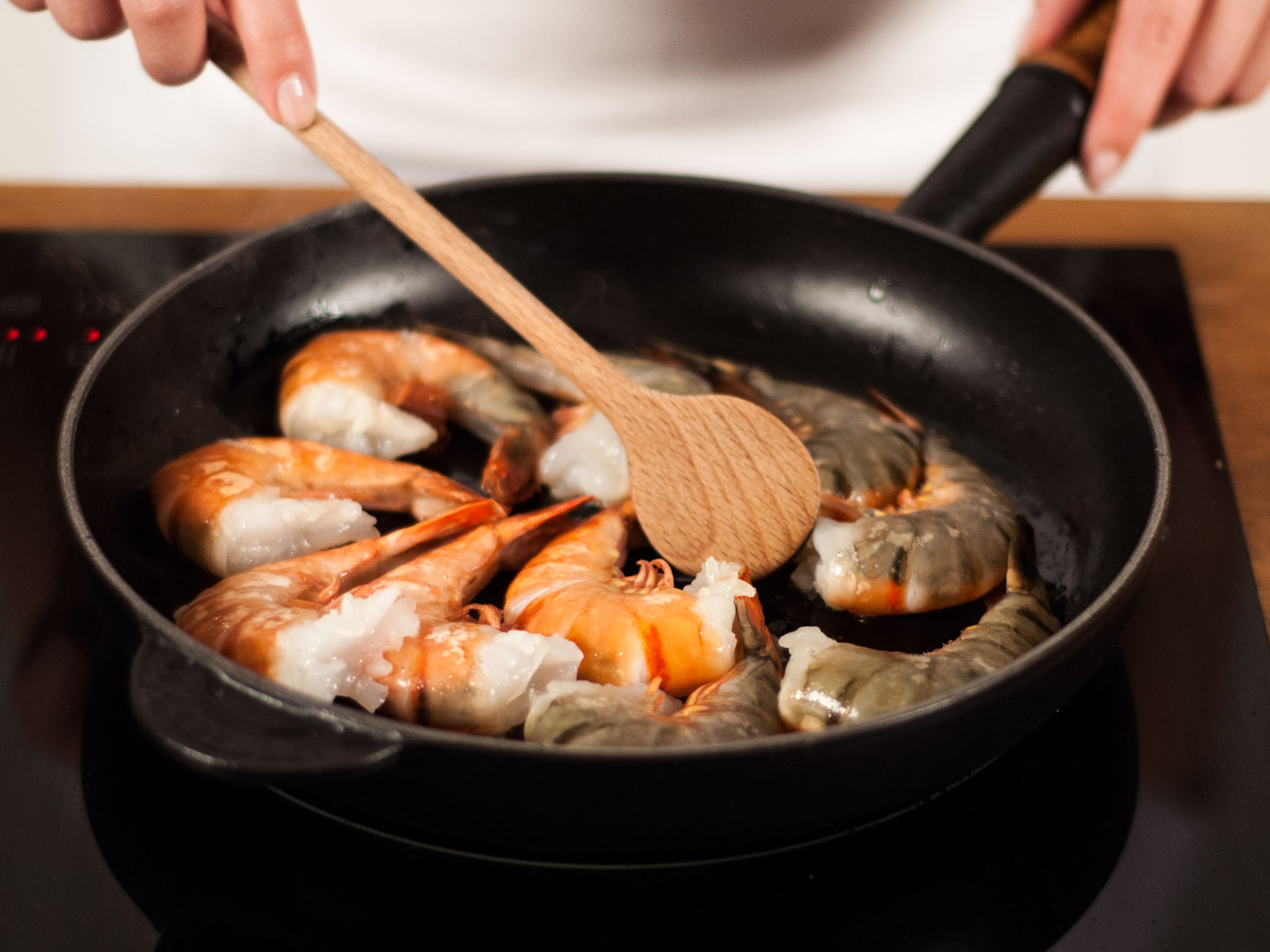 Heat some vegetable oil in a frying pan over medium heat. Add shrimp and sauté for approx. 1 min. on each side until red.