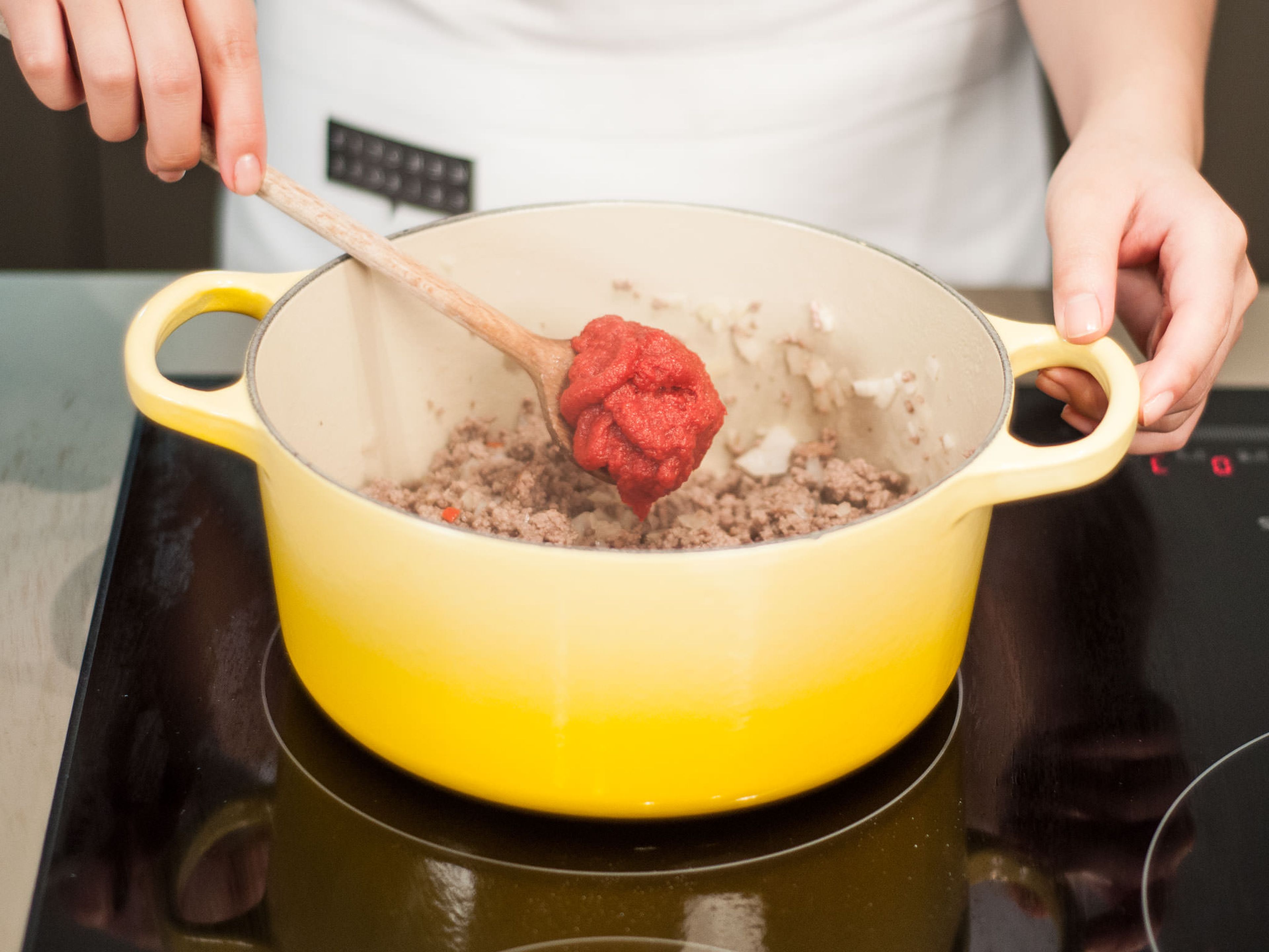 Add tomato paste to saucepan and continue to sauté for approx. 2 – 3 min. Season with salt and pepper.