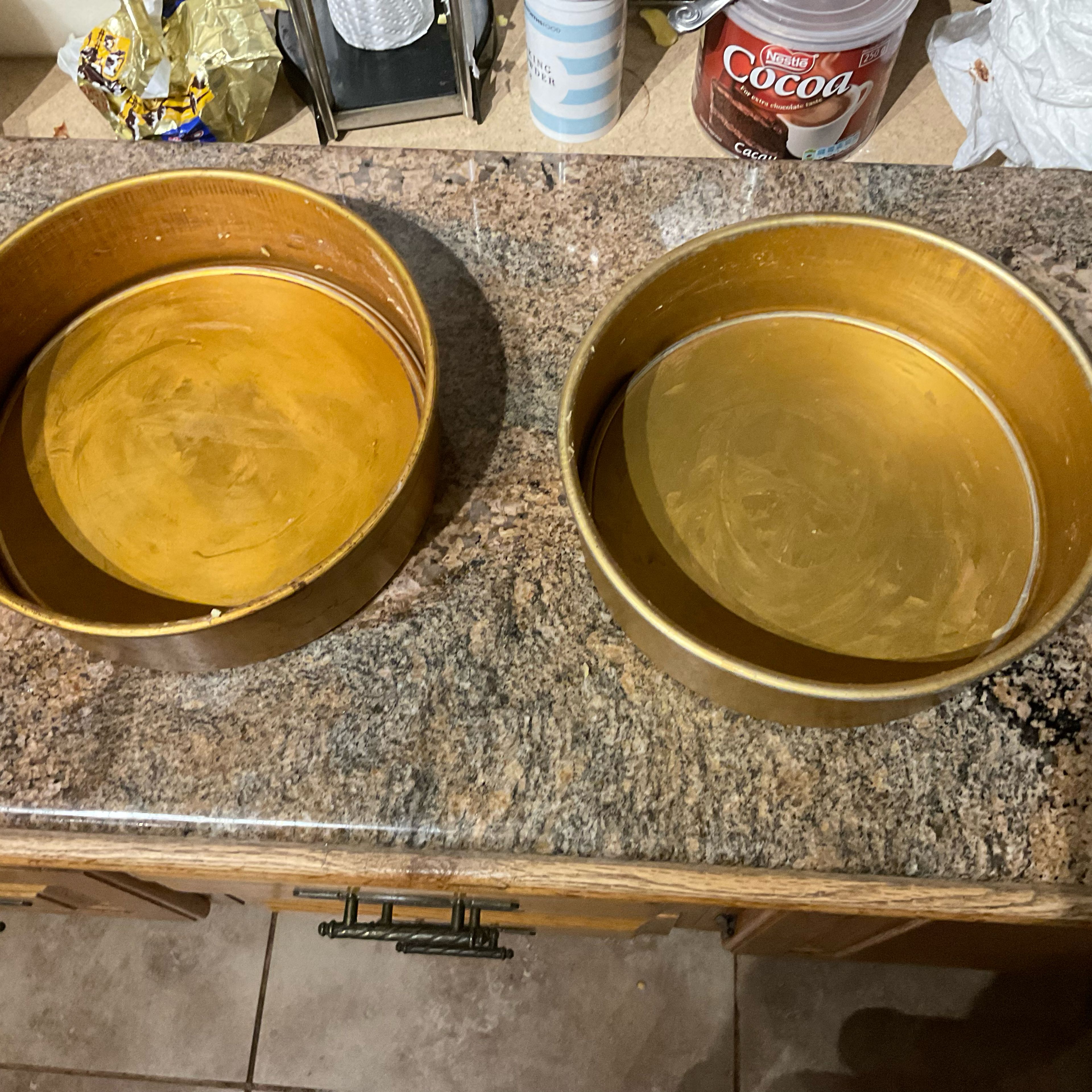 Grease the cake pans with butter
