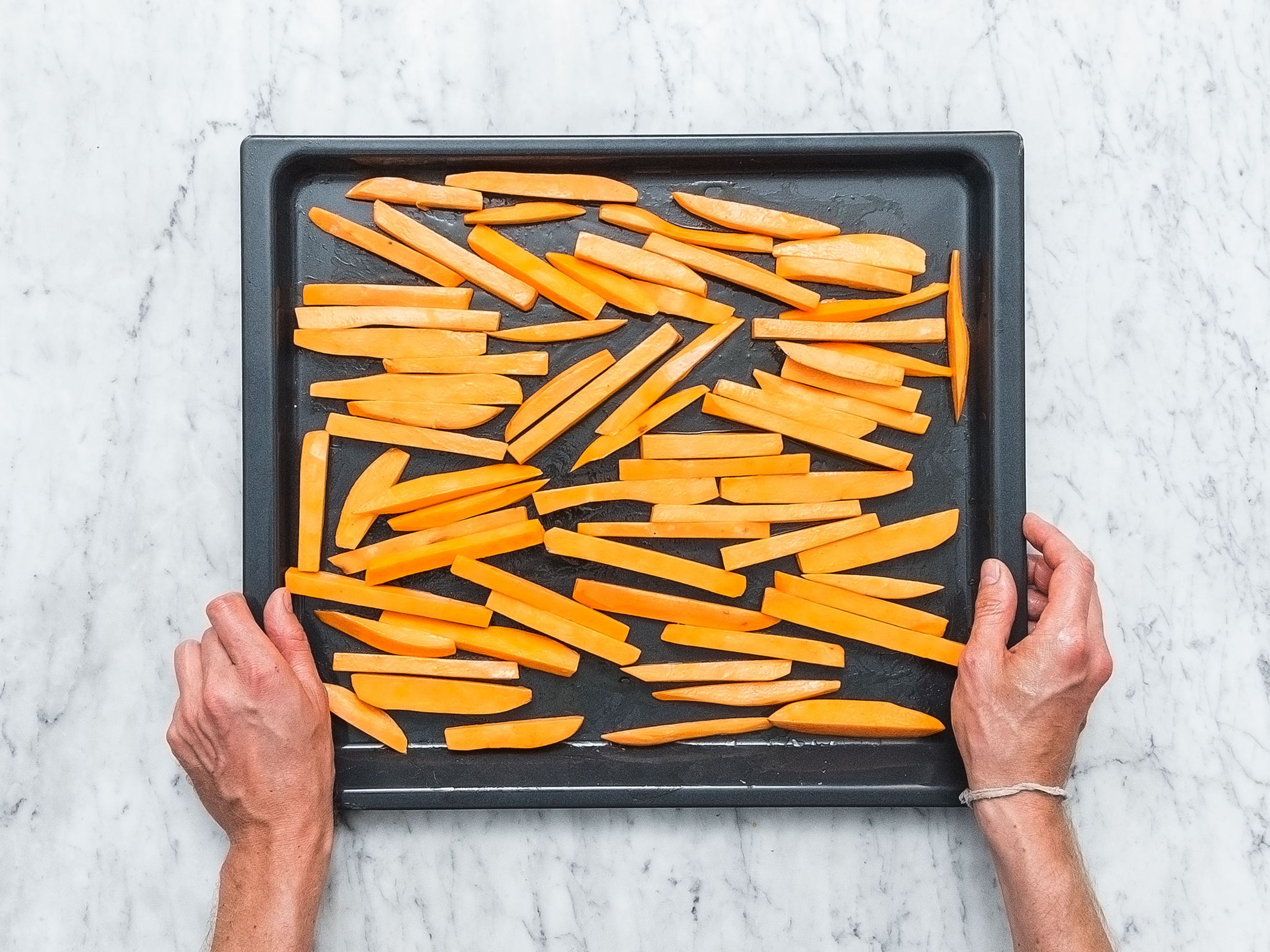 Pre-heat oven to 220°C/430°F. Cut sweet potatoes into matchsticks and transfer them to a large bowl. Add cornstarch and toss to coat. Spread sweet potato fries over a baking sheet. Add some oil and smoked ground paprika and toss to coat. Bake for approx. 20 min. or until golden-brown and crisp. Remove from oven and season with salt to taste.