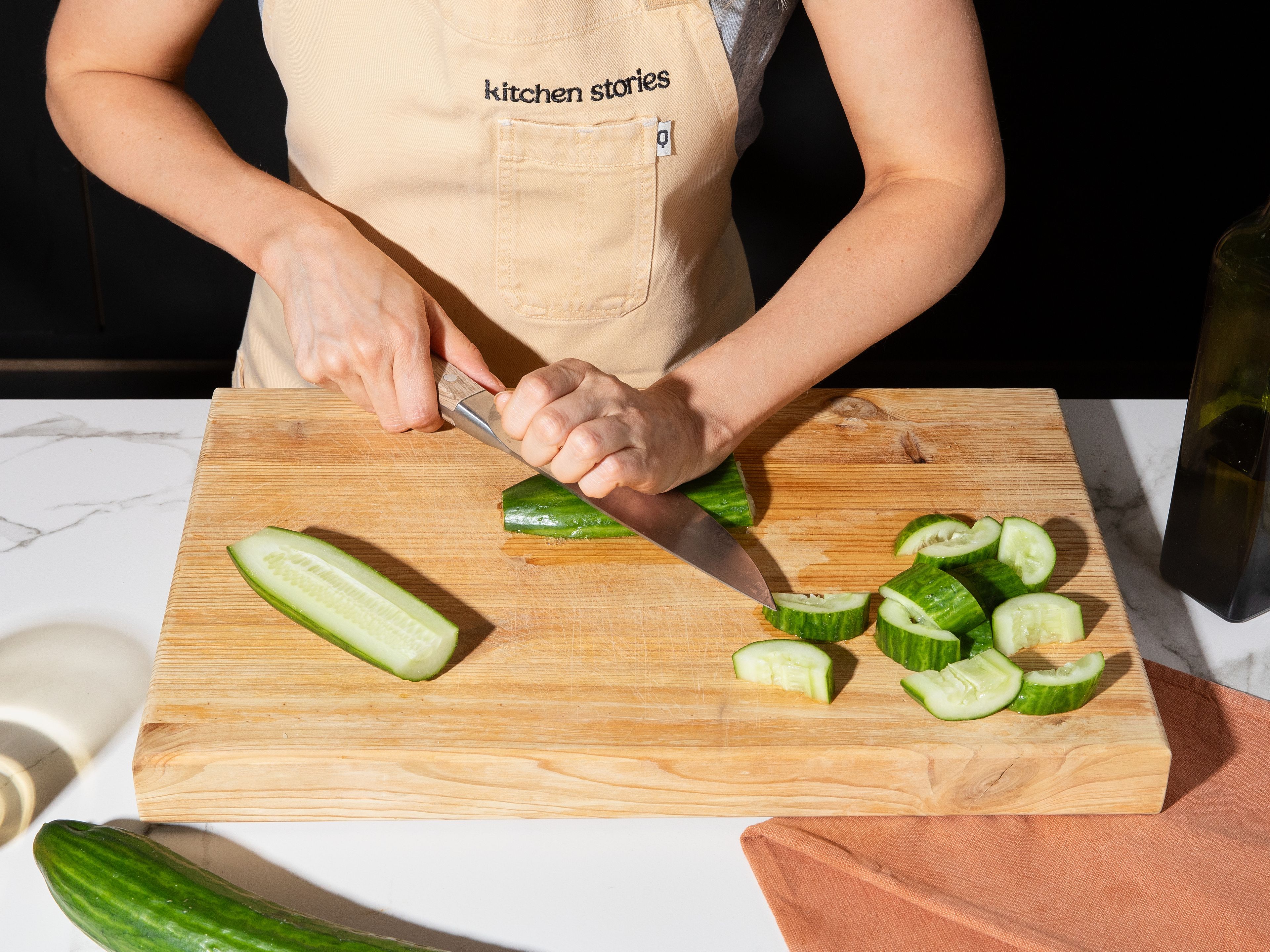 Meanwhile, smash cucumbers slightly using a knife or rolling pin, cut into bite-sized pieces, and mix with a little salt. Let sit for a moment to release water, then drain excess liquid.