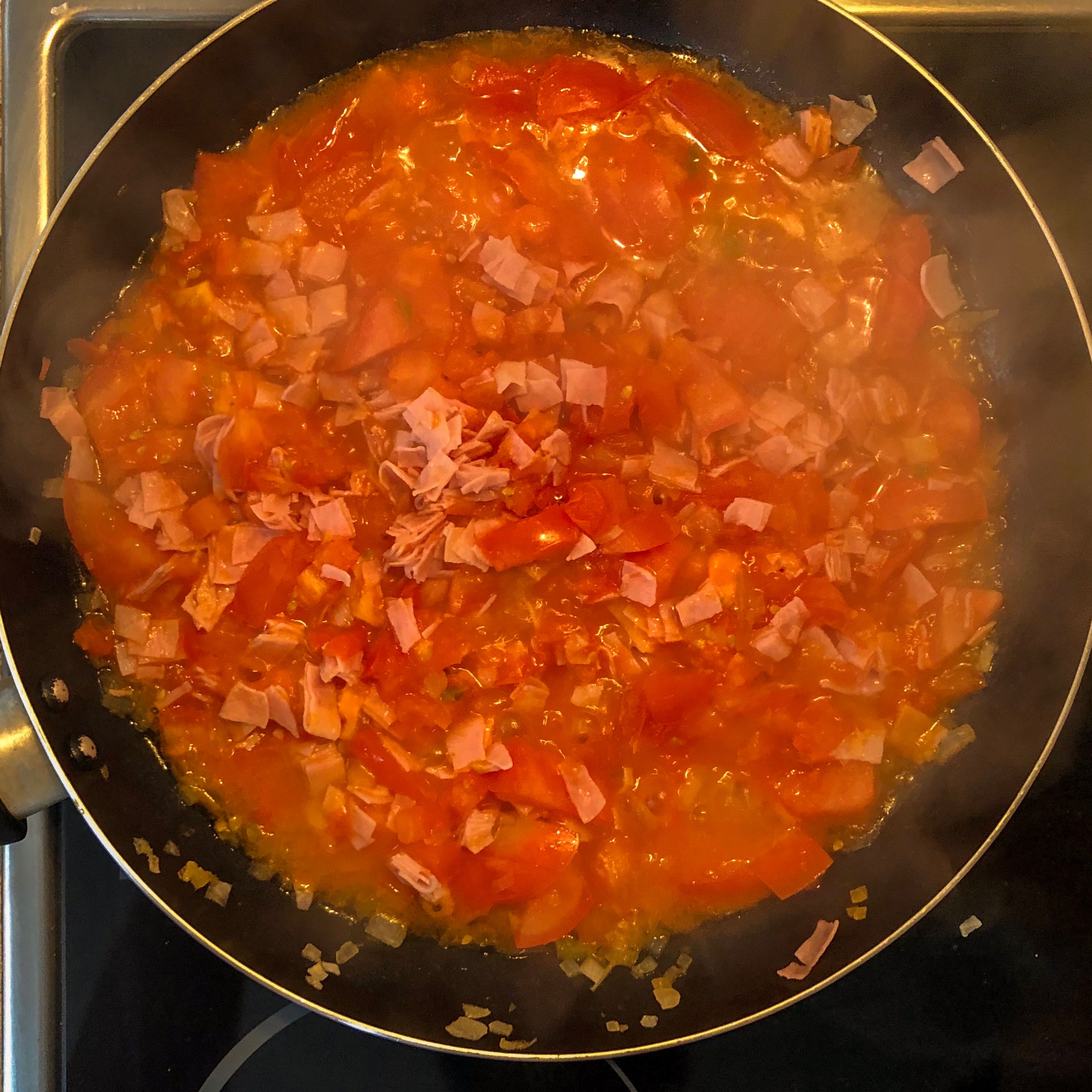 Add your tomatoes and set stove to medium low heat. When tomatoes are soften add your ham and let it cook and season with salt and pepper. Stir around on occasions.