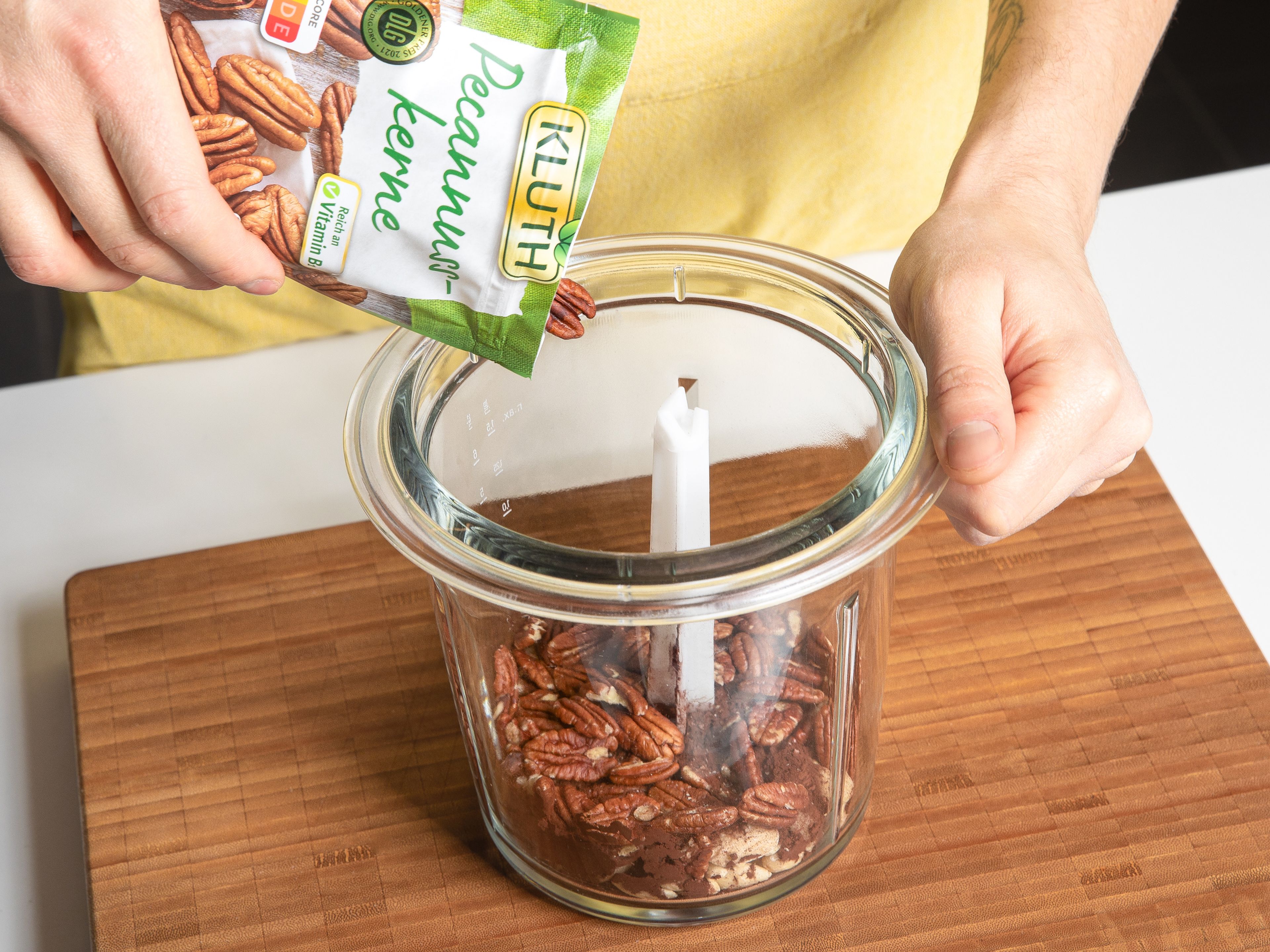 Grind pecans, almonds, some of the cocoa powder, and salt in a food processor. Add dates and water and mix until the ingredients come together into a thick paste.