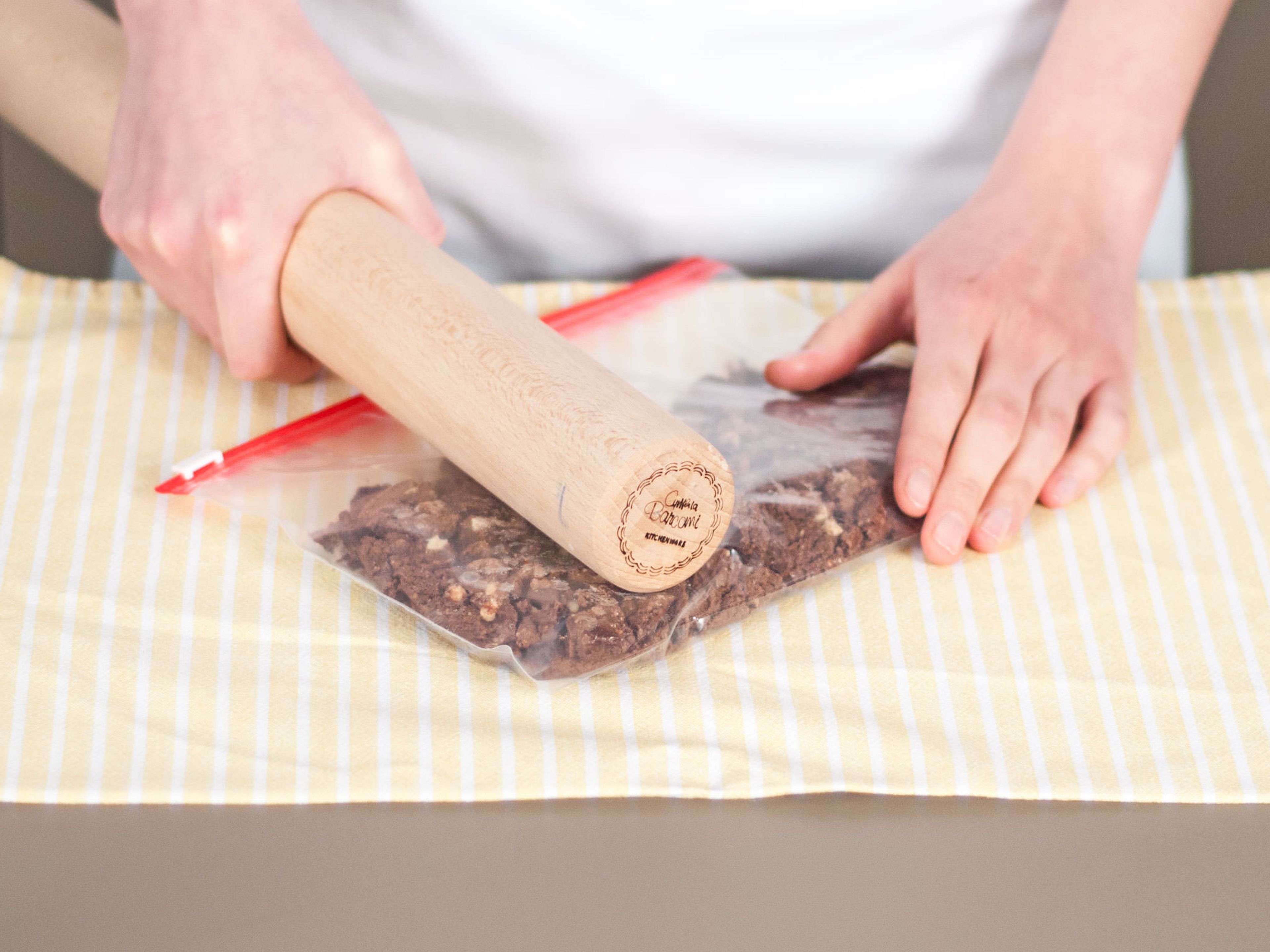 Place cookies into a freezer bag. Tightly seal bag and crush cookies with a rolling pin.