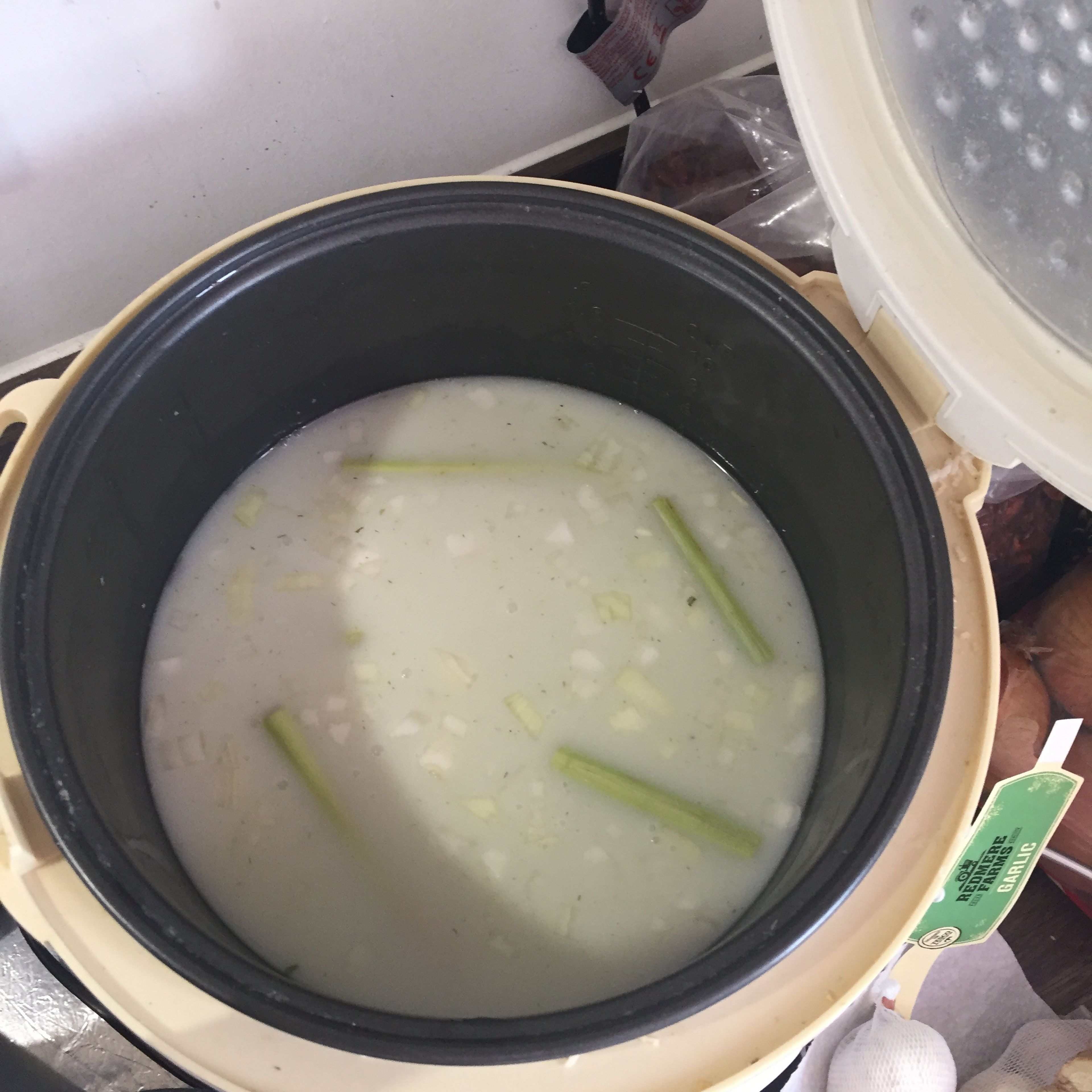 Then smash the lemongrass and cut it in half. Add it into the pot with the onions and coconut milk. Tie the pandan leaves into a knot and add it into the pot as well. Substitute for other forms such as 3-4 tsp of pandan powder