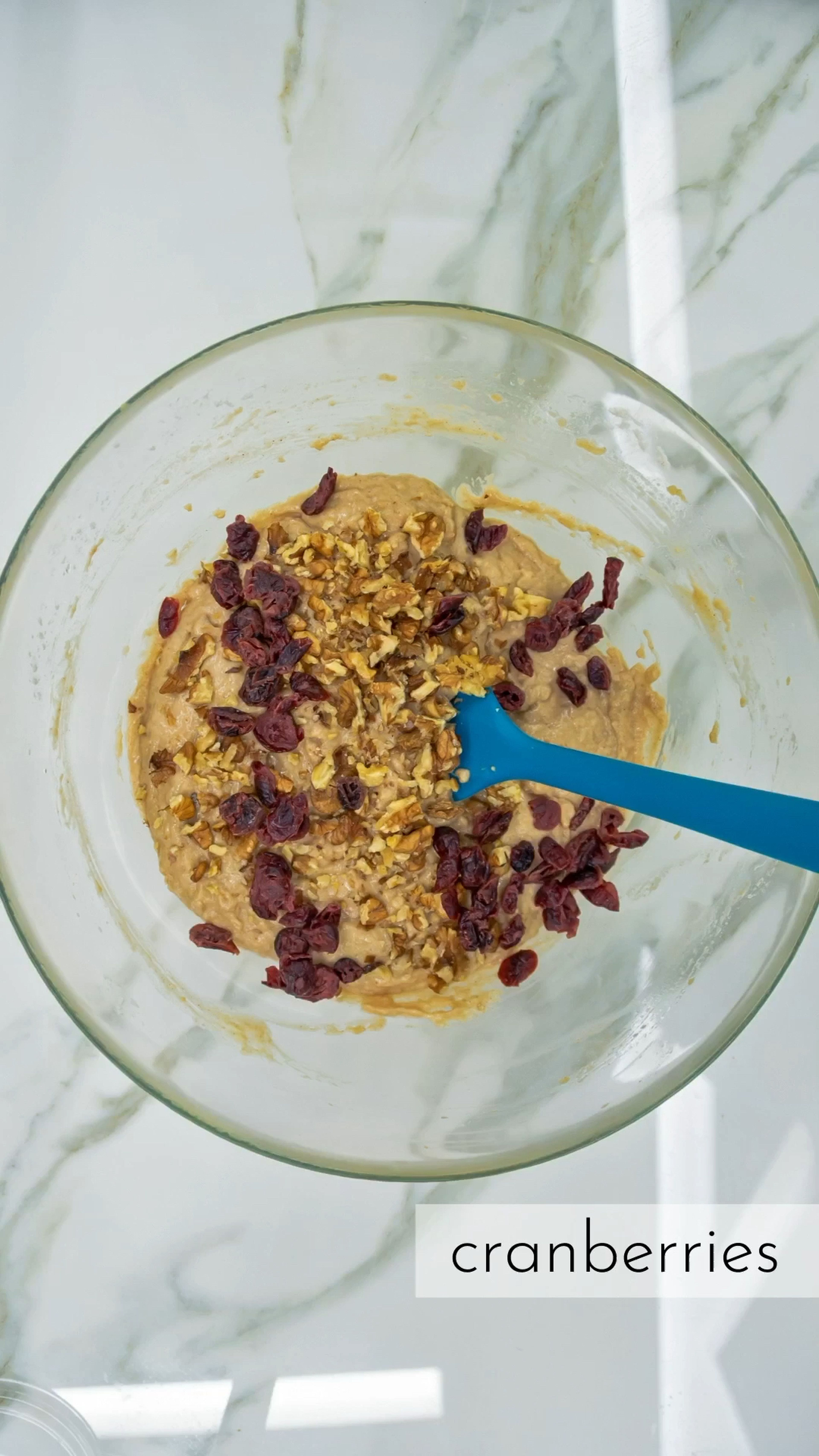 Fold the wet ingredients in with the dry ingredients until fully combined, and add in the walnuts and cranberries if using. Do not over mix.