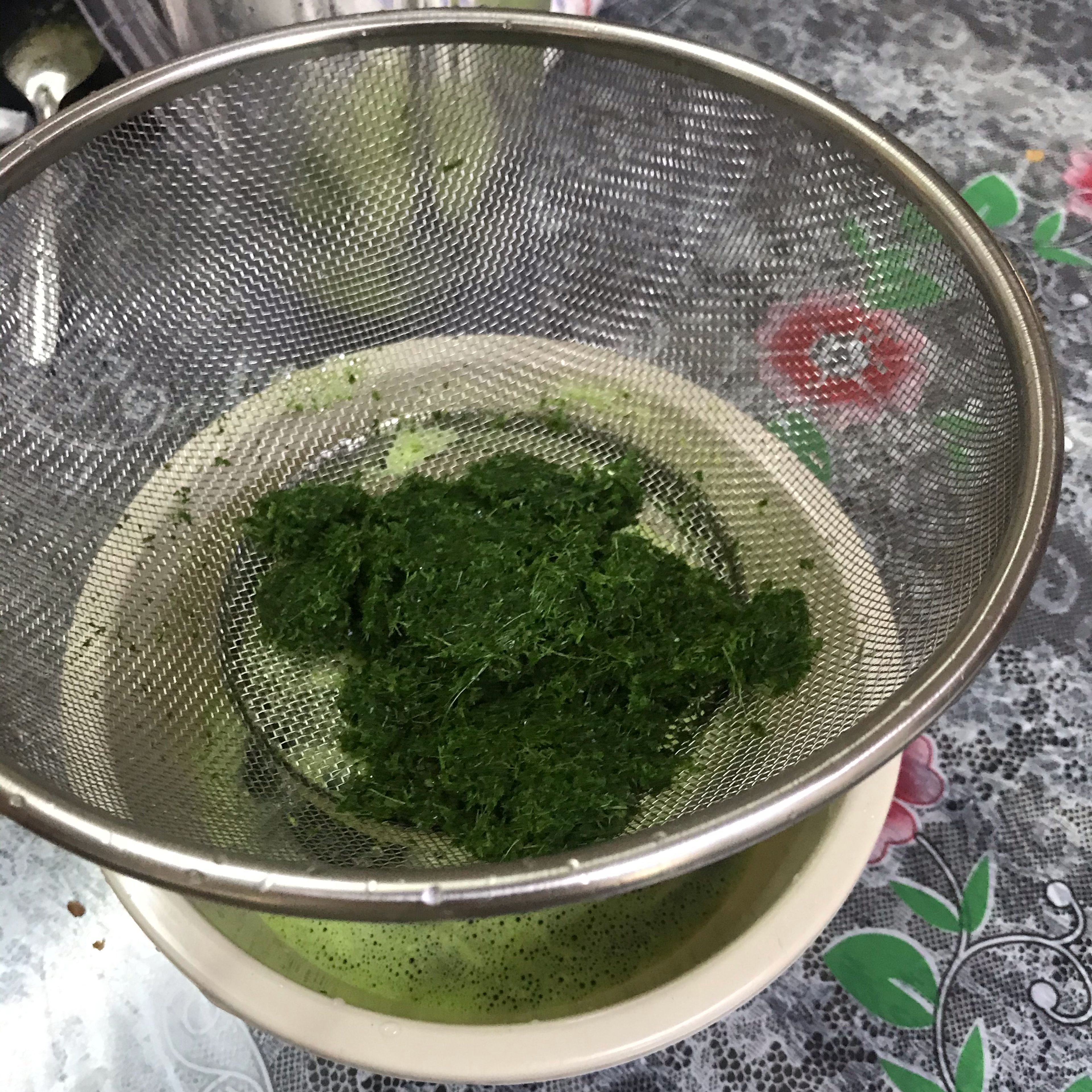 after the pandan leaves got blended, filter it into a bowl. press the pandan leaves to get the water out of it