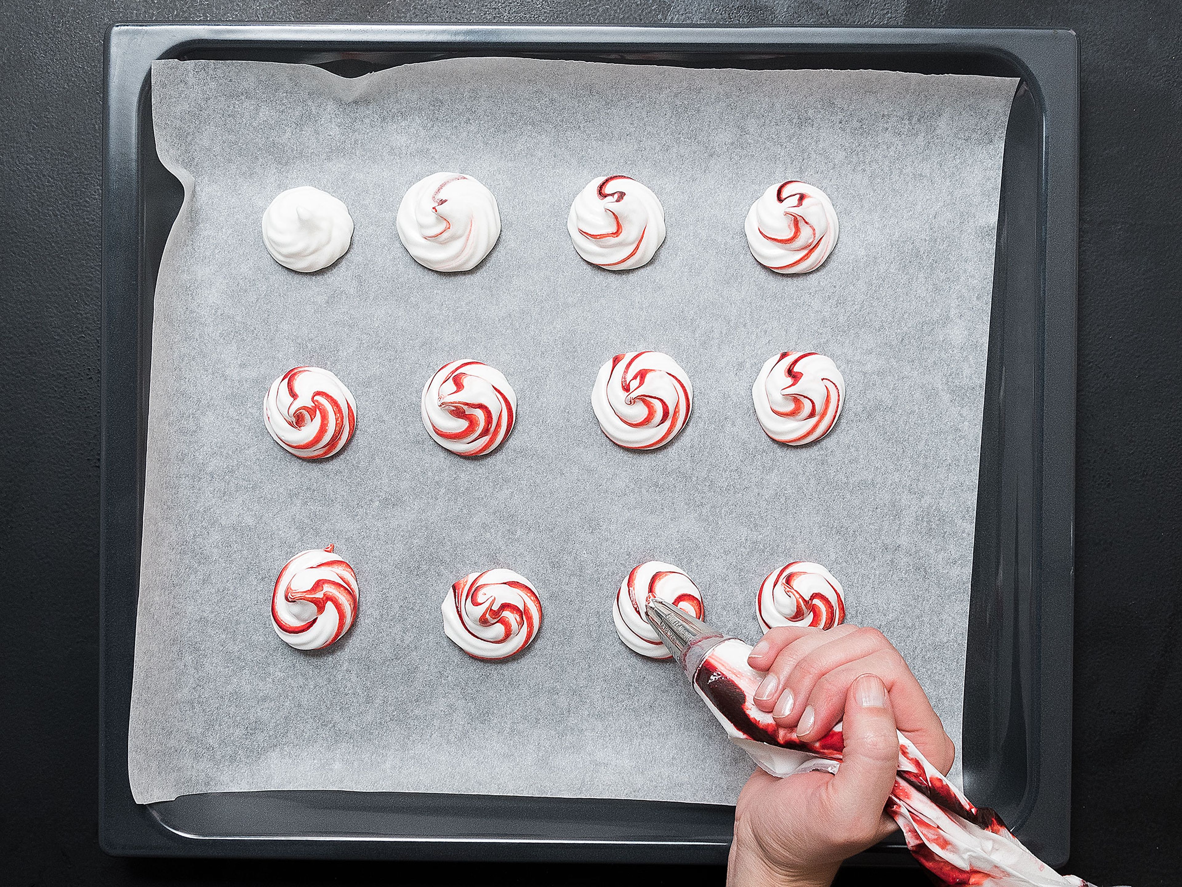 Pipe the meringue onto a parchment-lined baking sheet in circles approx. 4 cm/1.5 in. in diameter and 2.5 cm/1 in. high. Reduce heat to 120°C/250°F and bake for approx. 2 hrs., or until the meringues are firm. Crack the oven door open with a wooden spoon and let cool and dry slowly.