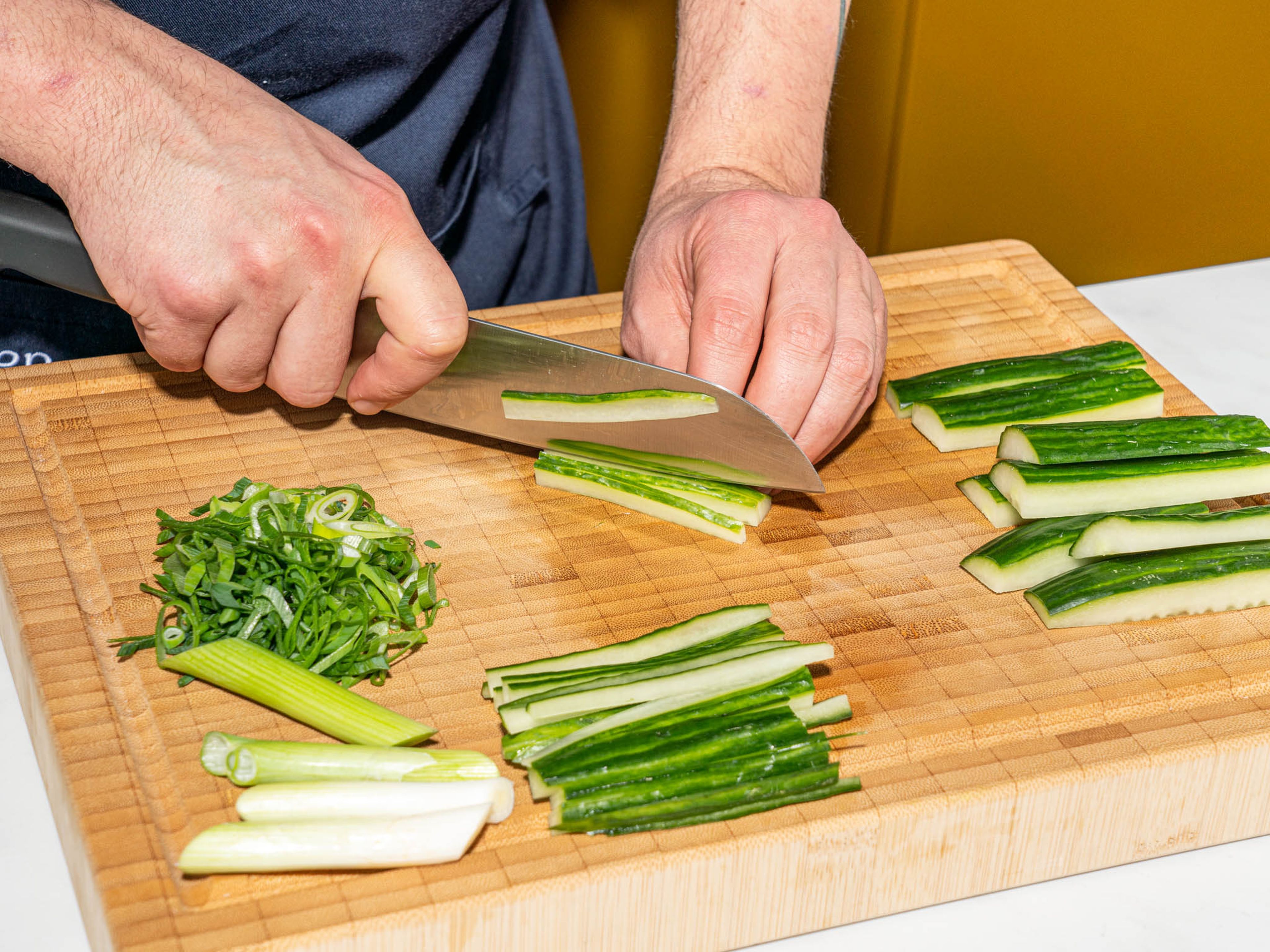 Separate scallion whites and greens. Cut white parts into thin strips, approx. 5 cm/2in in length and slice the green parts into rings on the diagonal. Finely julienne cucumber. Roughly chop ginger.